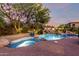 Expansive backyard oasis with a large pool, spa, and waterfall feature at 10906 E Southwind Ln, Scottsdale, AZ 85262