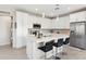 Modern kitchen featuring white cabinetry, island, and stainless steel appliances at 155 N Lakeview Blvd # 232, Chandler, AZ 85225