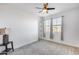 Bedroom with carpeted flooring, ceiling fan, and window with curtains at 18373 W Christy Dr, Surprise, AZ 85388