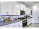 White shaker cabinets, granite counters, and gas cooktop at 22520 E Rosa Rd, Queen Creek, AZ 85142