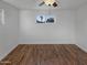 Spacious bedroom with wood-look flooring and a window at 2940 W Royal Palm Rd, Phoenix, AZ 85051