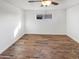 Bright bedroom featuring wood-look flooring and ceiling fan at 2940 W Royal Palm Rd, Phoenix, AZ 85051