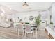 Open concept dining area with white table and chairs, hardwood floors at 3466 E Turnberry Dr, Gilbert, AZ 85298