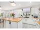 Kitchen with white cabinets, wood countertops, and a farmhouse sink at 3466 E Turnberry Dr, Gilbert, AZ 85298