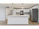 Modern kitchen with white cabinets, stainless steel appliances, and an island at 3523 E Thunderbird Rd, Phoenix, AZ 85032