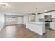 Open concept living room and kitchen with wood-look tile floors at 3523 E Thunderbird Rd, Phoenix, AZ 85032