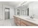 Double vanity bathroom with wood cabinets and tile flooring at 418 W Bentrup St, Chandler, AZ 85225