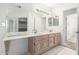 Bathroom featuring dual sinks, wood cabinetry, and tile floors at 418 W Bentrup St, Chandler, AZ 85225