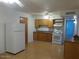 Galley style kitchen with wood cabinets and appliances at 429 W Greenwich Rd, Kearny, AZ 85137