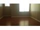 Bright bedroom with wood flooring and large window at 45638 W Dirk St, Maricopa, AZ 85139