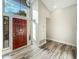 Light and airy entryway with wood-look tile floors and a solid wood door at 5016 E Marconi Ave, Scottsdale, AZ 85254