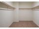 Large walk-in closet with double hanging rods and carpet flooring at 5817 W Moody Trl, Laveen, AZ 85339