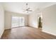 Bright bedroom with wood-look floors and sliding glass door to patio at 6015 W Kings Ave, Glendale, AZ 85306