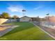 Artificial turf and a kidney-shaped pool at 610 W Medina Ave, Mesa, AZ 85210
