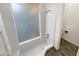 Updated bathroom with a shower/tub combo and tile flooring at 610 W Medina Ave, Mesa, AZ 85210