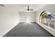 Bright bedroom with grey carpet and arched window at 610 W Medina Ave, Mesa, AZ 85210