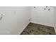 Clean laundry room with tile floors and built-in shelving at 610 W Medina Ave, Mesa, AZ 85210