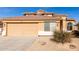 Tan two-story house with a double-car garage and desert landscaping at 6526 W Briles Rd, Phoenix, AZ 85083