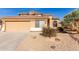 Tan two-story house with a double-car garage and desert landscaping at 6526 W Briles Rd, Phoenix, AZ 85083