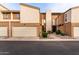 Front view of tan townhome with attached garage and walkway at 6533 N 10Th Pl, Phoenix, AZ 85014