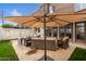 Backyard patio with seating area and large umbrella at 6533 N 10Th Pl, Phoenix, AZ 85014