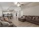 Spacious living room with L-shaped sofa and view into kitchen at 7008 W Mitchell Dr, Phoenix, AZ 85033