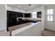 Modern kitchen with dark cabinetry, granite countertops, and stainless steel appliances at 7813 W Palm Ln, Phoenix, AZ 85035