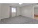 Spacious bedroom with neutral walls, grey carpet, and window at 7950 E Keats Ave # 156, Mesa, AZ 85209