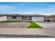 Single-story home with landscaped yard and attached garage at 8109 E Madero Ave, Mesa, AZ 85209