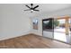 Bright bedroom with wood floors and sliding door to patio at 9209 E Emerald Dr, Sun Lakes, AZ 85248