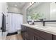 Modern bathroom boasts double sinks, a shower, and an elegant mirror at 933 E Piedmont Rd, Phoenix, AZ 85042