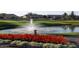 Water fountain and vibrant red flowers in a landscaped community area at 9733 E Lompoc Ave, Mesa, AZ 85209