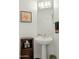 Simple bathroom with pedestal sink and wood floor at 1040 E Osborn Rd # 1201, Phoenix, AZ 85014