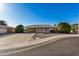 Ranch-style home with carport and landscaped front yard at 14228 N Sierra Dawn Way, Sun City, AZ 85351