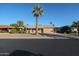 Tan one-story house with a palm tree and driveway at 14823 N Bolivar Dr, Sun City, AZ 85351