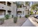 Exterior view of an apartment building with landscaping and parking at 15095 N Thompson Peak Pkwy # 2114, Scottsdale, AZ 85260