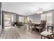 Dining area with wood-look flooring, modern light fixture, and large window at 15912 W Marconi Ave, Surprise, AZ 85374