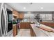 Kitchen featuring wood cabinets, stainless steel appliances, and large center island at 15912 W Marconi Ave, Surprise, AZ 85374