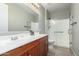 Bathroom with wood cabinets, single vanity and shower at 17826 W Straight Arrow Ln, Surprise, AZ 85387