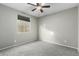Small bedroom with grey carpet and ceiling fan at 17826 W Straight Arrow Ln, Surprise, AZ 85387