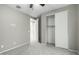 Small bedroom with grey carpet and a closet at 17826 W Straight Arrow Ln, Surprise, AZ 85387