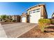 Houses with a three-car garage and brick driveway at 17826 W Straight Arrow Ln, Surprise, AZ 85387