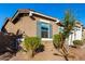 Tan one-story house with a two-car garage and landscaping at 17826 W Straight Arrow Ln, Surprise, AZ 85387