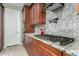 Modern kitchen features granite countertops and dark wood cabinets at 17826 W Straight Arrow Ln, Surprise, AZ 85387