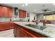 Kitchen with wood cabinets, granite counters and island at 17826 W Straight Arrow Ln, Surprise, AZ 85387