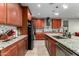 Kitchen with wood cabinets, granite counters and island at 17826 W Straight Arrow Ln, Surprise, AZ 85387