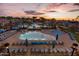 Community pool with plenty of lounge chairs and umbrellas at 21627 W Mariposa St, Buckeye, AZ 85396