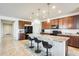 Modern kitchen with granite island and dark wood cabinets at 21686 N 259Th Dr, Buckeye, AZ 85396