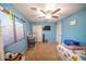 Blue bedroom with ceiling fan, window blinds, and carpeted floor at 23914 N 25Th Way, Phoenix, AZ 85024