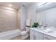 Bathroom with a tub, shower, white vanity, and neutral tile at 3131 N Central Ave # 5022, Phoenix, AZ 85012